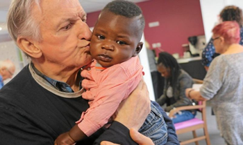 Homme âgé embrassant un enfant en bas âge